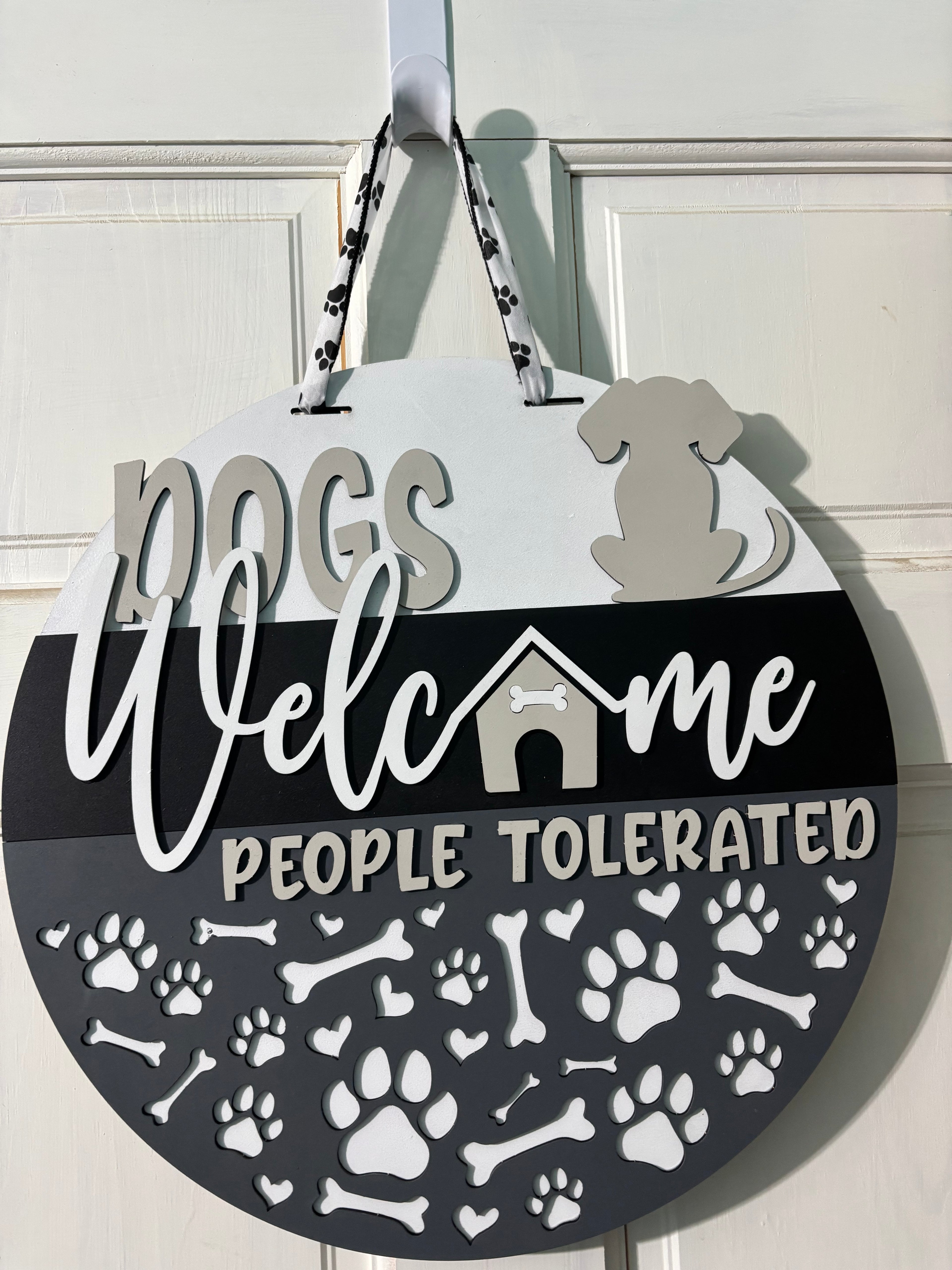 Door Hanger Dogs Welcome People Tolerated in light and dark greys 16 inch
