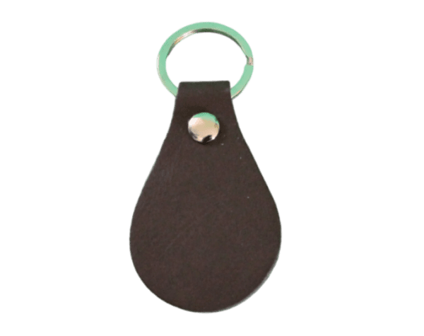 A brown leather key chain with green ring.