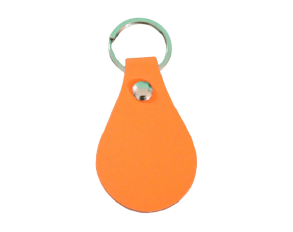 A key chain with an orange tear drop shaped object.