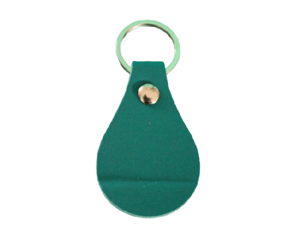 A green key chain with a gold bell on top.