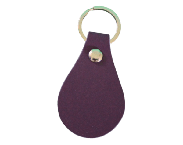 A purple leather key chain with gold colored ring.