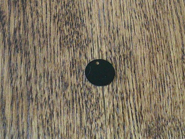 A black circle is on the wood floor