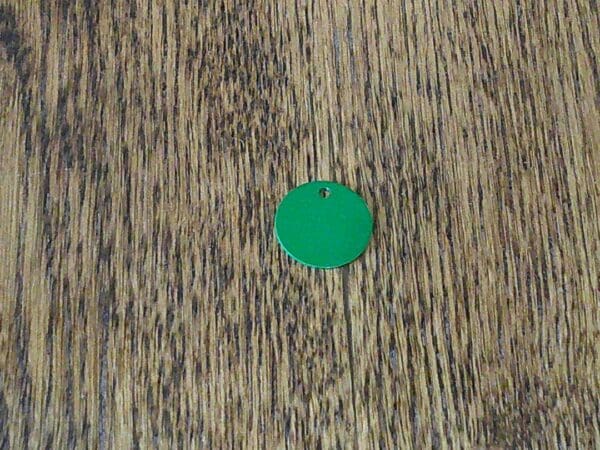 A green circle on top of a wooden surface.