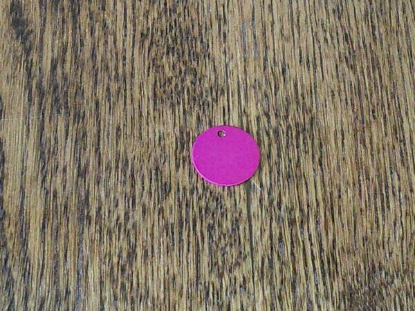 A pink circle on top of a wooden surface.