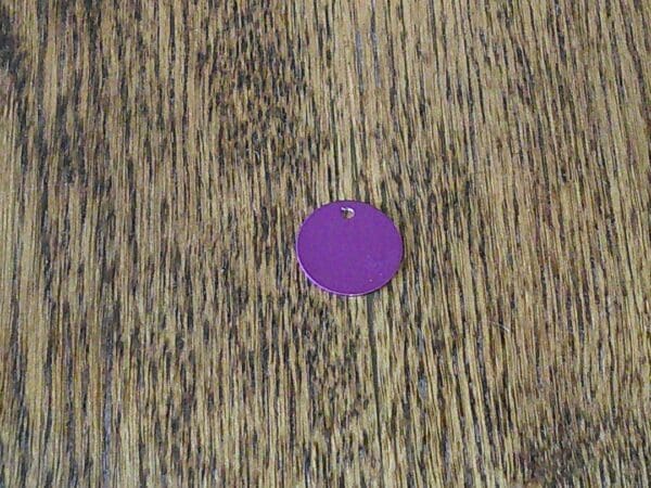 A purple circle on top of a wooden surface.