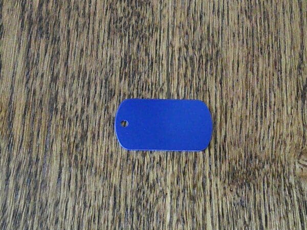 A blue tag sitting on top of a wooden floor.