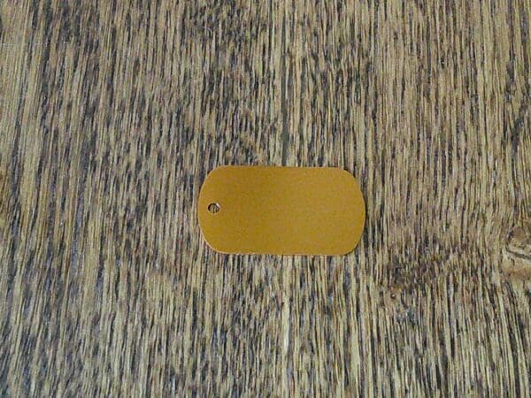 A dog tag sitting on top of a wooden floor.