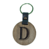 A wooden key chain with the letter d on it.